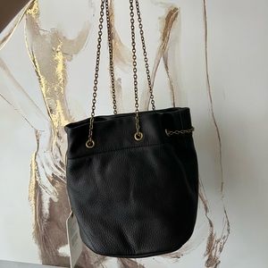 HOBO bag. It’s accented with a gold chain.